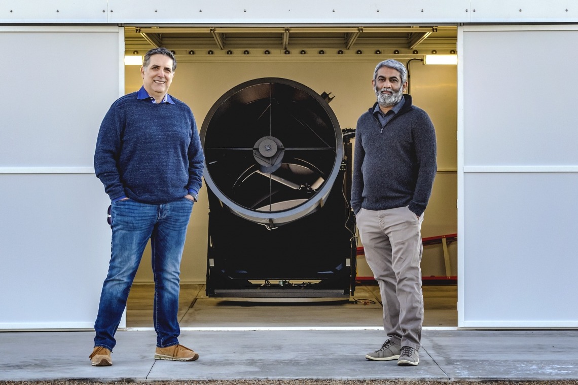 Robert Furfaro and Vishnu Reddy standing next to machine